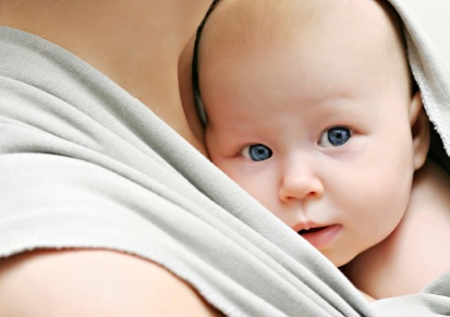 Baby in sling carrier