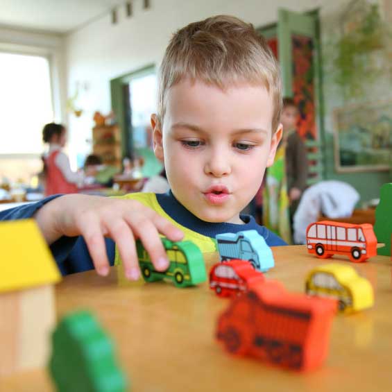 Child playing with blocks before clean up struggle