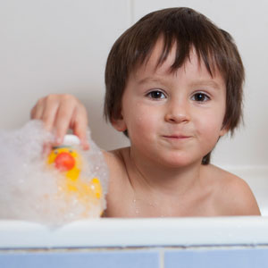 Toddler playing in bath