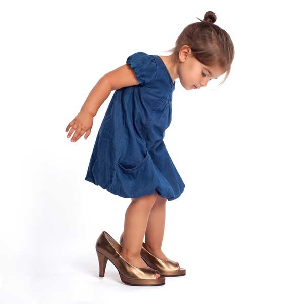 child trying to fill adult shoes